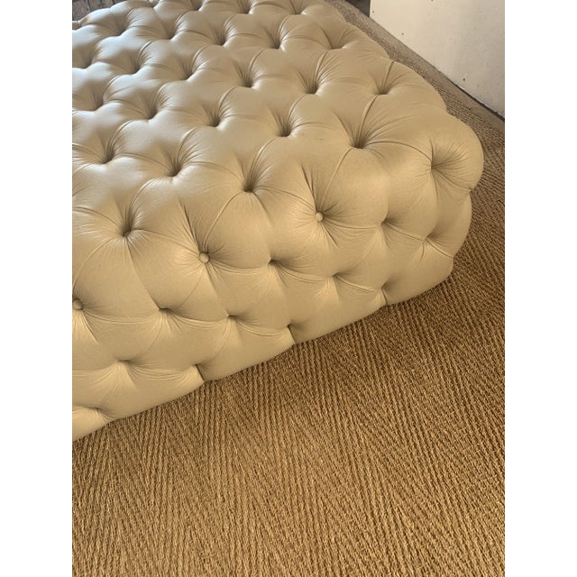 Vintage tufted leather ottoman. Soft leather in very good condition. Statement piece for large open seating area.