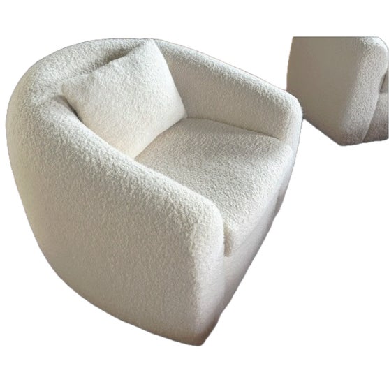 A pair of sophisticated, designer, custom swivel chairs custom made for a client, featuring a modern, circular silhouette...