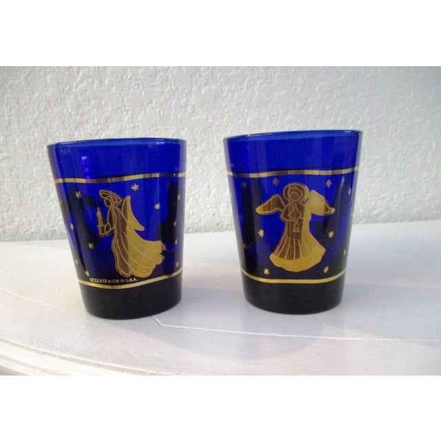 Gorgeous set of four Culver cobalt blue holiday double lowball glasses featuring a generous 22 karat gold angel and star...