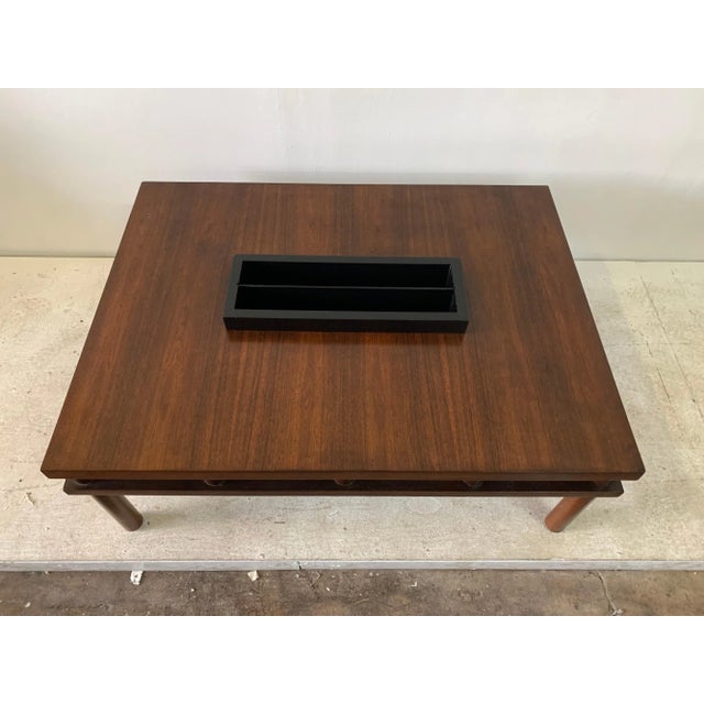 A rare midcentury design by T. H. Robsjohn-Gibbings coffee table with center magazine holder box which is removable. A...