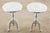 Sleek pair of polished metal round pedestal drink tables crafted from cast aluminum with a chrome like finish. The round...