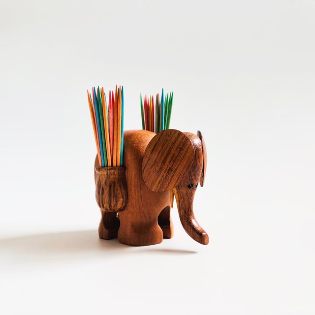 An adorable Mid Century elephant toothpick holder. Lovely natural grain to the wood. Features 2 pockets on the sides for...
