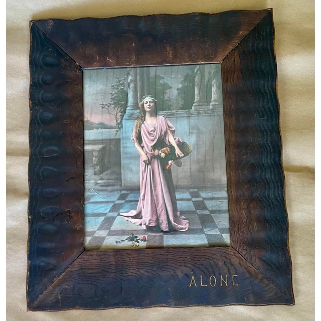 This frame is hand carved in a wonderfully simple style with a wave like surface and a scalloped edge. It is finished with...