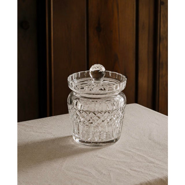 A beautifully crafted cut crystal biscuit jar with matching lid, circa 1950s–60s. The cylindrical body features an all-...