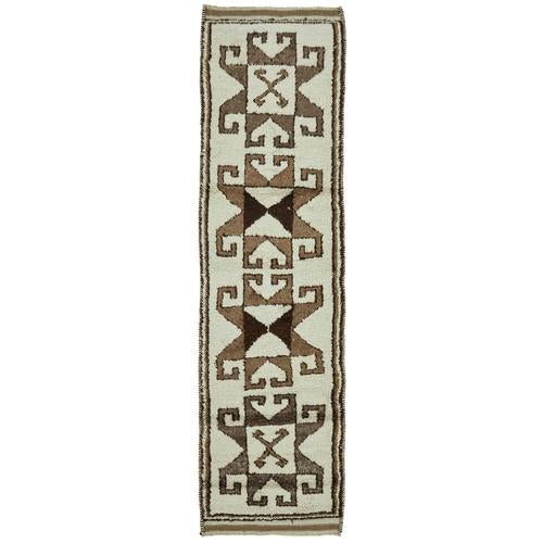 This exquisite runner rug is a rare example of tribal craftsmanship, hand-knotted by the women of the Herki tribe during...