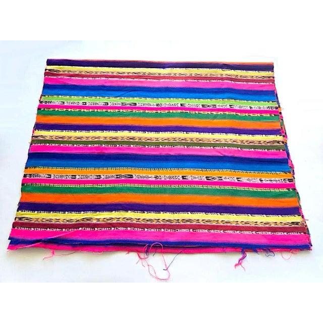 Offered is a vintage handwoven Guatemalan textile in brightly colored stripes with numerous joint bands of their jaspe...