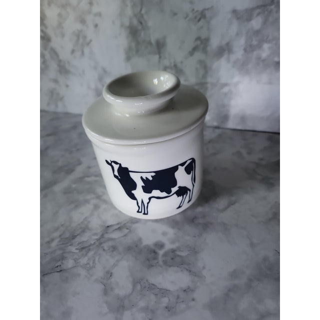 Farmhouse modern ceramic butter bell featuring a charming black and white Hostein cow. Butter is placed in perforated top...