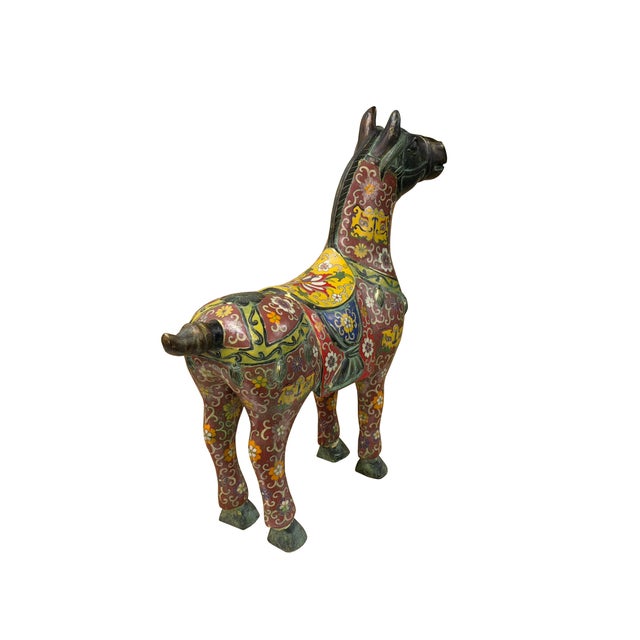 This striking bronze horse sculpture showcases a remarkable integration of metalwork and vibrant cloisonné enameling. The...