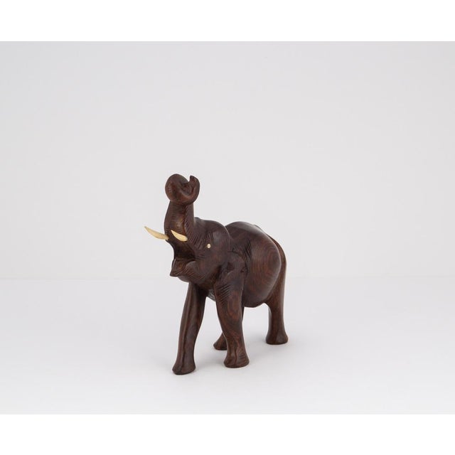 A charming example of 1960s sculptural craftsmanship, this compact elephant figure captivates with its flowing lines and...