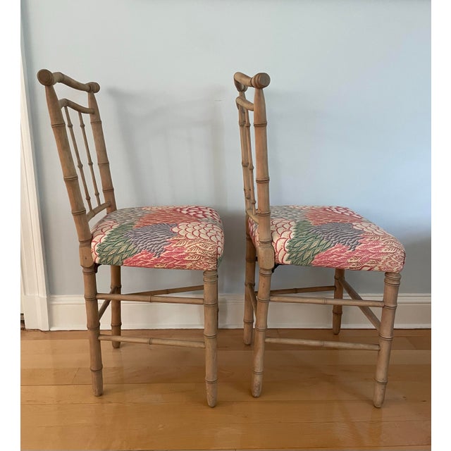 This delicate pair of side chairs are a carved faux bamboo with curved backs for comfort. The seats are upholstered in a...