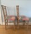 This delicate pair of side chairs are a carved faux bamboo with curved backs for comfort. The seats are upholstered in a...