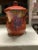 This cookie jar/canister features a delightful hand, painted design of fruits and leaves. The jars rich, warm tones, and...