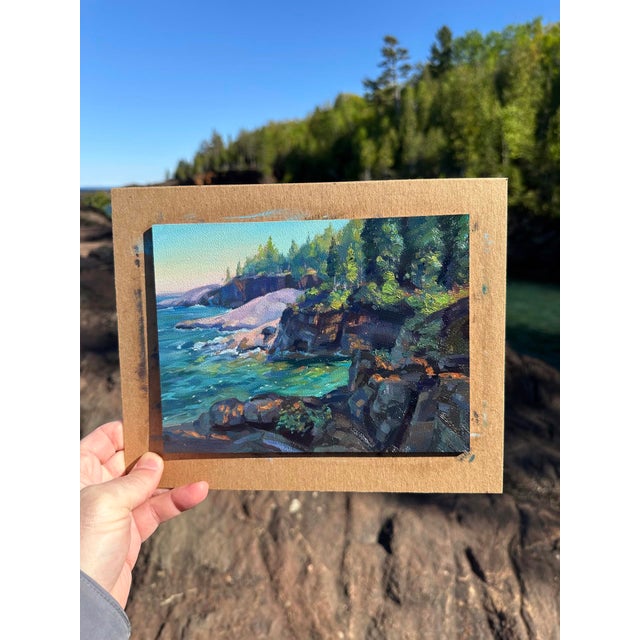 This oil painting captures a serene coastal scene at Presque Isle, showcasing rugged cliffs adorned with vibrant greenery...
