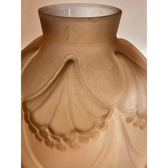 Art Deco pressed-molded glass vase A spherical vase with a narrow neck, made of molded pink glass with a matte satin...