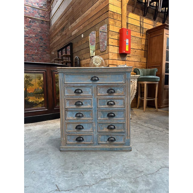 This antique fir workshop cabinet has been fully restored. It features one large, functional drawer and 10 smaller, also...