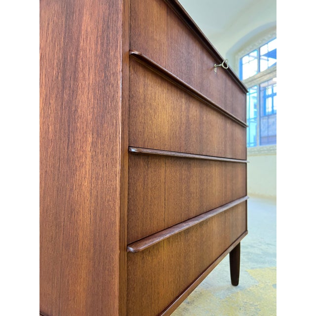 In its restored splendor, this Danish teak chest of drawers presents itself as a versatile gem for any living space. Its...