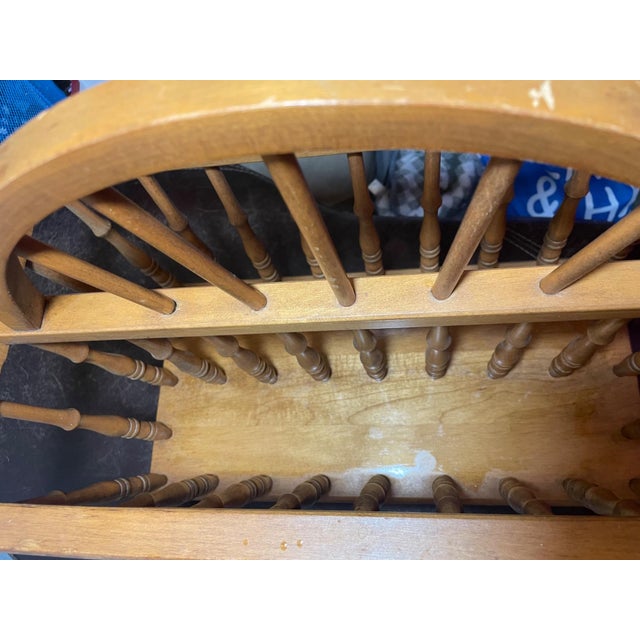 This vintage wooden magazine rack features classic turned spindle sides and an arched handle, offering timeless farmhouse...