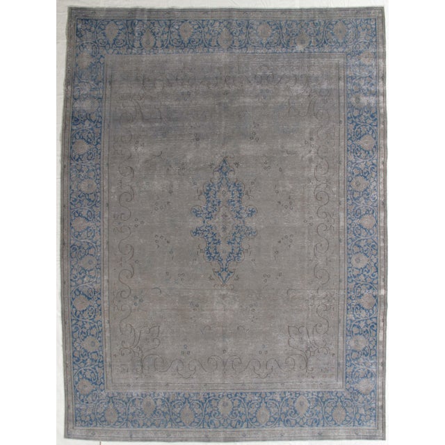Vintage hand-knotted wool rug with a muted gray field and faded blue medallion and border design, creating a distressed,...