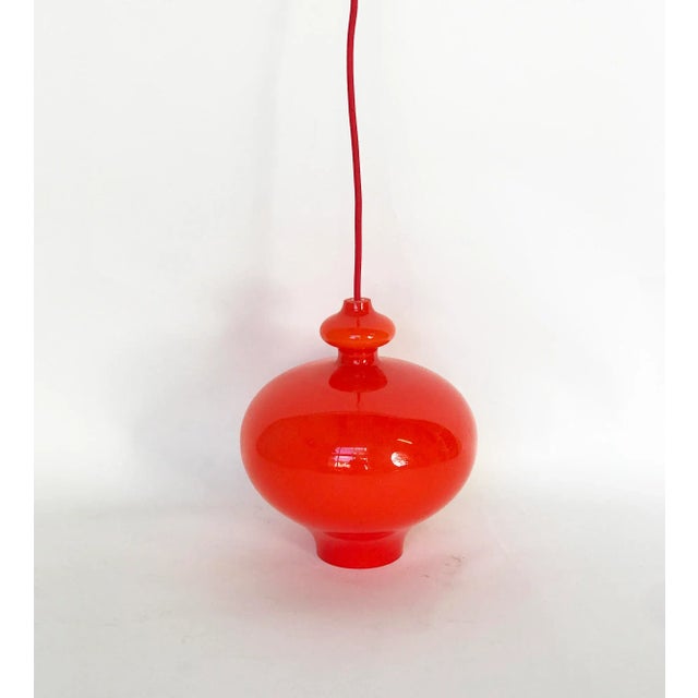 Bright and warm Orange glass outside and white inside. Stunning lamp for its color and the way it is shaped. It has been...