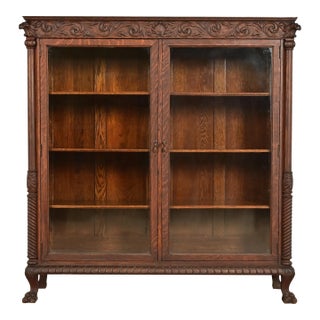 R. J. Horner Style Victorian Oak Double Bookcase With Carved Lion Heads and Paw Feet, Circa 1890s For Sale