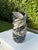 A striking contemporary studio pottery vessel featuring a bold sculptural ribbon form with an architectural black-and-...