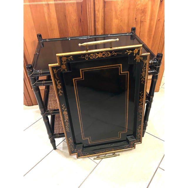 This piece blends classical, floral Chinoiserie motifs with mid-century elegance. It features a striking tray top,...