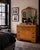A beautifully crafted late 1930s Art Deco dresser with its original matching mirror, distinguished by book-matched...