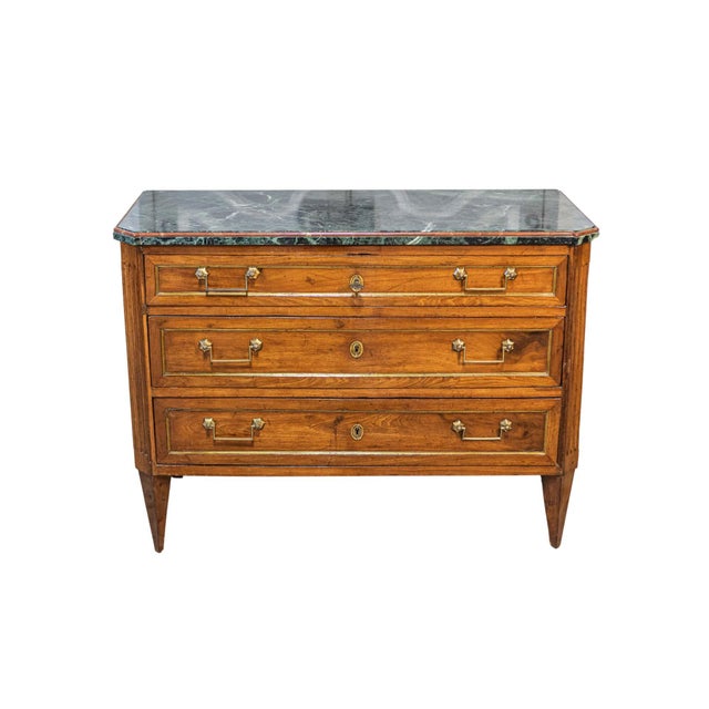 An Italian Neoclassical style Piemontese walnut commode from circa 1890 with three drawers and dark green marble top. This...