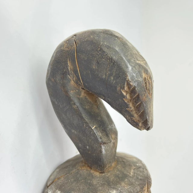 This carved wooden split gong originates from the Baule people of CÃ´te d'Ivoire. The instrument is sculpted from a single...