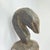This carved wooden split gong originates from the Baule people of CÃ´te d'Ivoire. The instrument is sculpted from a single...