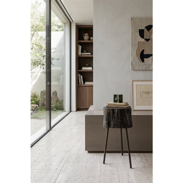 A sculptural side table made around 1970, characterized by the combination of a thick block of solid wood and a light...