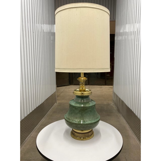Tall porcelain ginger jar lamp, with crackle glaze finish, brass trim, and large Frederick Cooper barrel shade,...