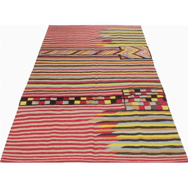 This bewitchingly beautiful example of a tribal Kilim area rug features a contemporary pop of electrifying bright colors...