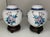 Bright bold twin ginger jars feature a blue floral motif with a crisp white background. The top of the lids have a bold...