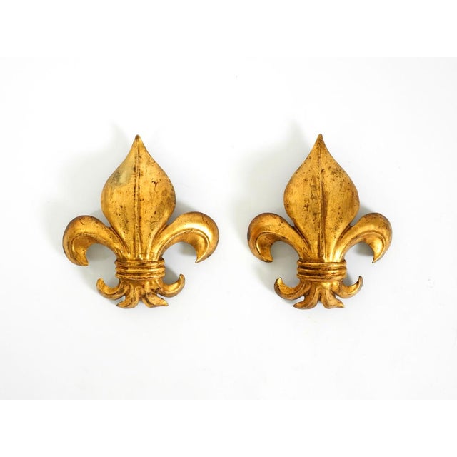 Two large gold-plated metal wall lamps from the 1970s. designed by hans kögl (fleur-de-lis model). beautiful design; the...