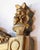 Elegant Louis XVI period mirror crafted in carved giltwood with a painted wood pediment, richly decorated with a covered...