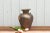 A tall country style Asian water vase found in Thailand. This rustic vessel has four miniature handles, a round body and a...