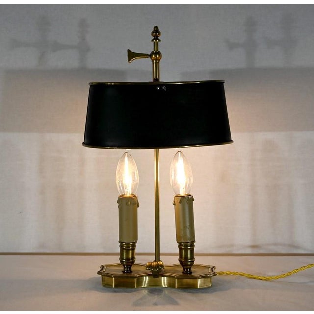 Small brass hot waterproof lamp overseen with a green sheet in green sheet and circled with brass. Adjustable in height,...