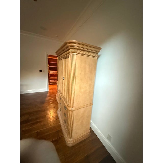 Beautiful Drexel Heritage armoire in a warm light oak finish. Features double doors with fluted paneling and three...