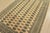 A tribal Bokhara rug hand-knotted with fine wool on a cotton foundation. This rug features rows of repeating medallions...