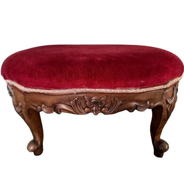 Vintage Louis XV style footstool. It has a wood (mahogany or walnut) frame and ornate cabriole legs with detailed...