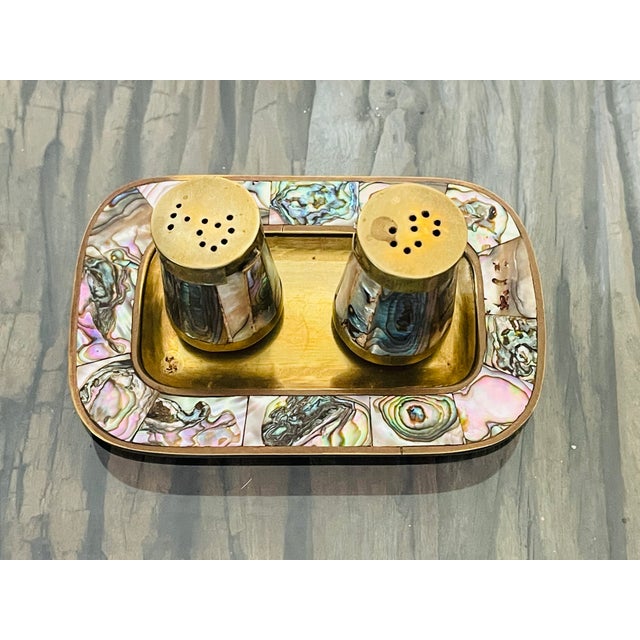 Beautiful brass metal with blue shell salt and pepper shakers with tray. Made in Mexico.