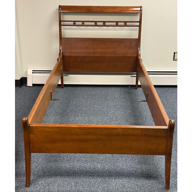 A handsome pair of vintage twin-size wooden bed frames featuring a warm medium-brown finish and elegant, understated...
