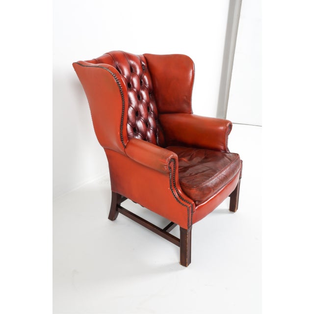 Wonderfully and perfectly patinated tufted back cognac leather with brass tacks accent trim. Loose down-filled seat...