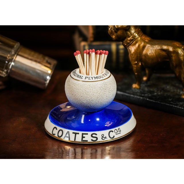 Experience a touch of vintage charm with this great looking hand-painted porcelain advertising match holder striker, a...