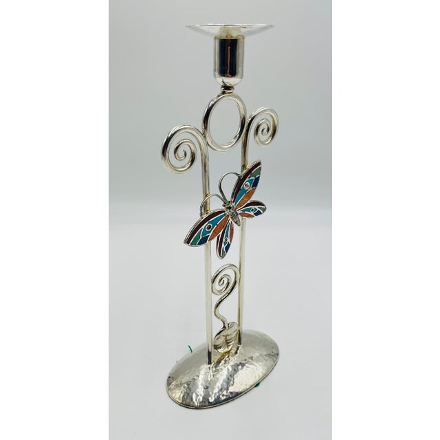 A charming and highly collectible silver-plated candle holder designed and handcrafted in Taxco, Mexico by acclaimed...
