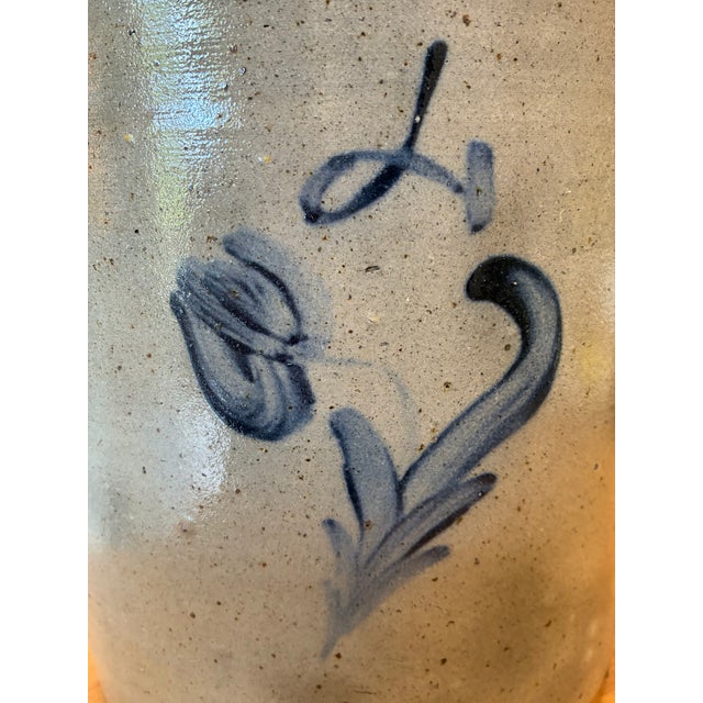 A timeless antique salt-glazed stoneware crock featuring a beautifully hand-painted cobalt blue floral design and classic...