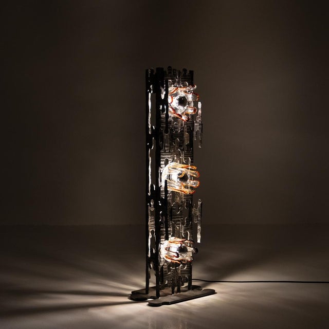 This striking Brutalist lamp from the 1970s is a sculptural composition of light and texture, crafted in the style of...