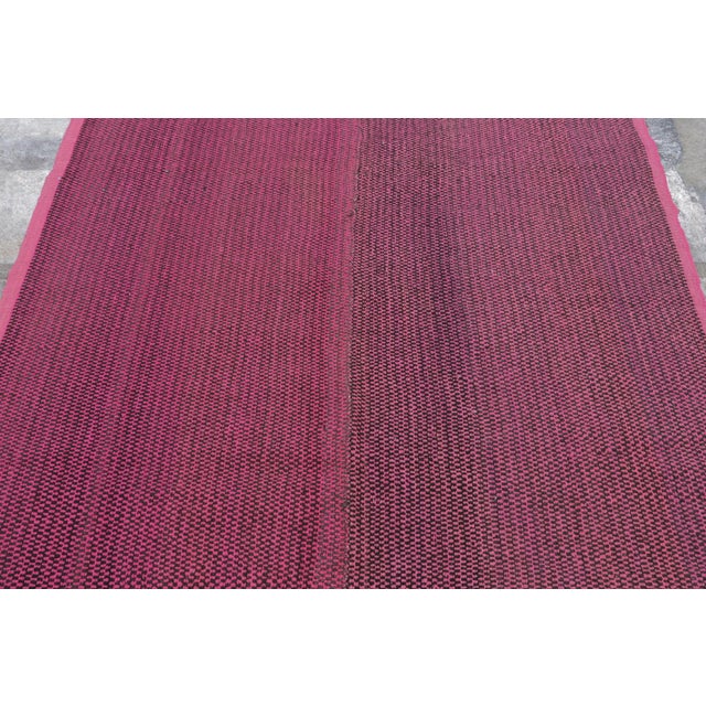 Handwoven in wool circa 1950–1960, this 5x6 vintage Kilim, woven in the tradition of a Frazada textile, is a subtle yet...