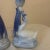 The candlesticks are made of white and blue ceramic, featuring a swan-like figure on a base of stylized waves. The swan's...